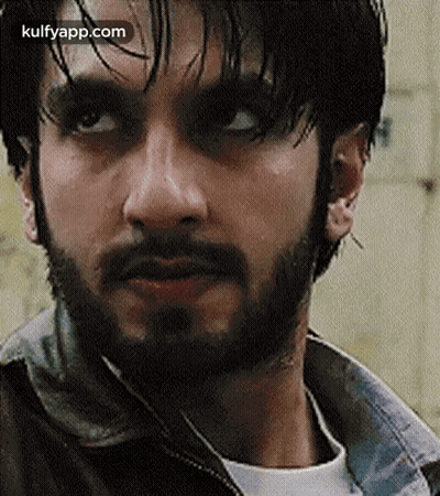 A Close Up Of A Man With A Beard Wearing A Jacket . GIF