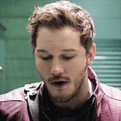 A Close Up Of A Man With A Beard Wearing A Purple Jacket . GIF
