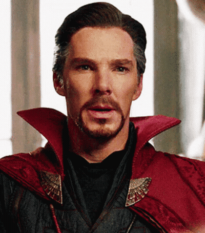 A Close Up Of A Man With A Beard Wearing A Red Cape And A Black Shirt . GIF