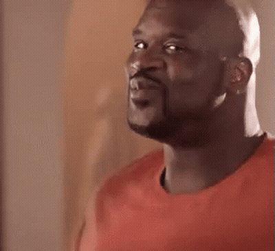 A Close Up Of A Man With A Beard Wearing A Red Shirt And Smiling . GIF