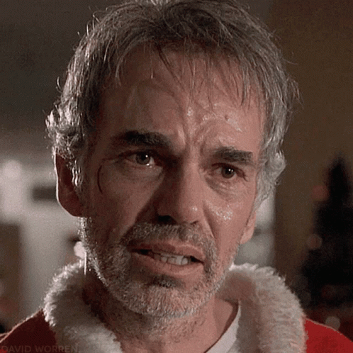 A Close Up Of A Man With A Beard Wearing A Santa Claus Costume GIF