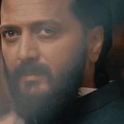 A Close Up Of A Man With A Beard Wearing A Suit And Tie GIF