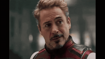A Close Up Of A Man With A Beard Wearing A Superhero Costume And Looking At The Camera . GIF