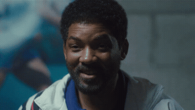 A Close Up Of A Man With A Beard Wearing A White Jacket GIF