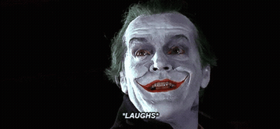 A Close Up Of A Man With A Fake Smile On His Face And The Words `` Laughs '' Written On The Bottom . GIF