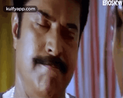 A Close Up Of A Man With A Mustache Making A Face . GIF