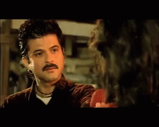 A Close Up Of A Man With A Mustache Making A Funny Face GIF