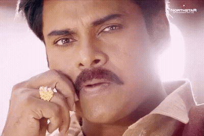 A Close Up Of A Man With A Mustache Wearing A Ring On His Finger . GIF