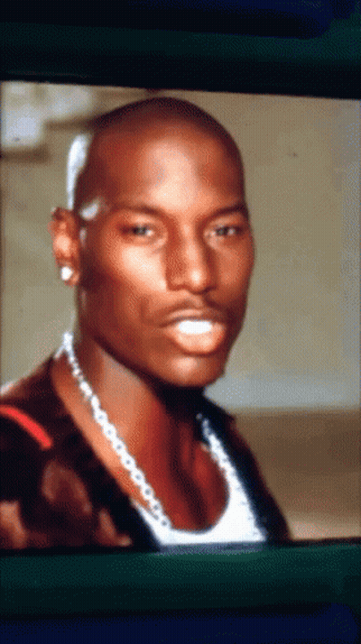 A Close Up Of A Man With A Necklace Around His Neck GIF