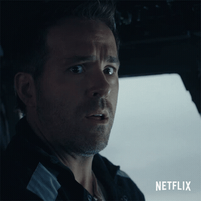 A Close Up Of A Man With A Netflix Logo Behind Him GIF