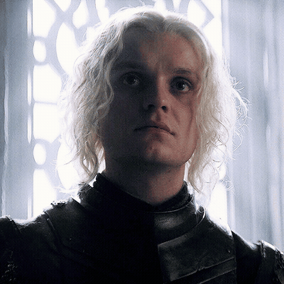 A Close Up Of A Man With Blonde Hair And A Black Jacket GIF