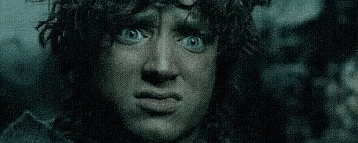 A Close Up Of A Man With Blue Eyes Making A Funny Face In The Dark . GIF