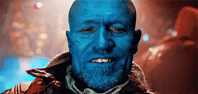 A Close Up Of A Man With Blue Skin And A Beard Smiling . GIF
