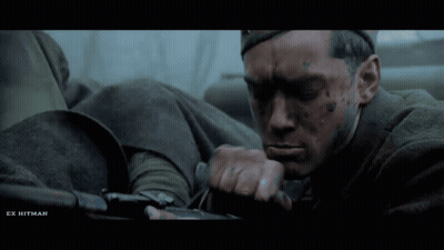 A Close Up Of A Man With Ex Hitman Written On The Bottom Right GIF
