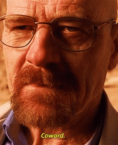 A Close Up Of A Man With Glasses And A Beard Says Coward GIF