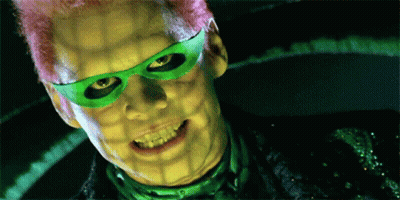 A Close Up Of A Man With Green Glasses And Pink Hair GIF