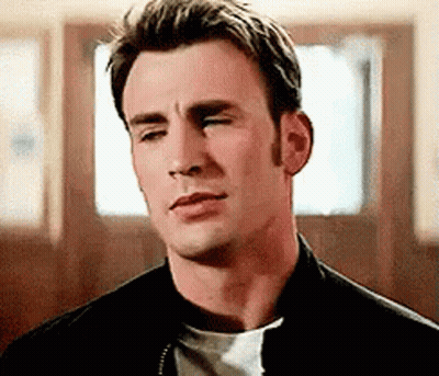 A Close Up Of A Man With His Eyes Closed Wearing A Black Jacket And A White Shirt . GIF