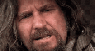 A Close Up Of A Man With Long Hair And A Beard Making A Face . GIF