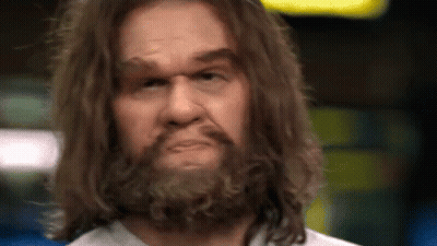 A Close Up Of A Man With Long Hair And A Beard Making A Funny Face . GIF