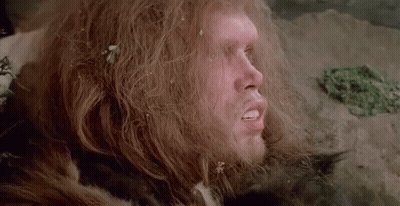 A Close Up Of A Man With Long Hair And A Fur Coat On . GIF