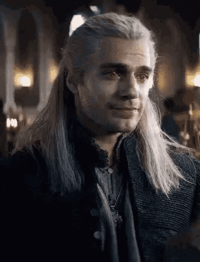 A Close Up Of A Man With Long White Hair Wearing A Black Jacket . GIF