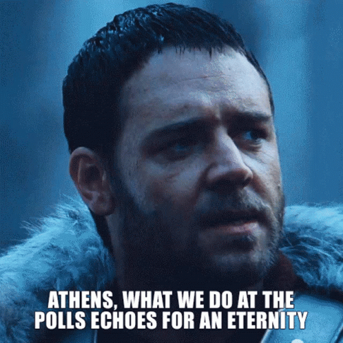 A Close Up Of A Man With The Words Athens What We Do At The Polls Echoes For An Eternity Below Him GIF