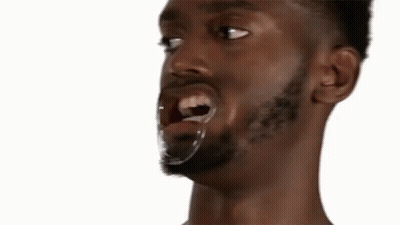 A Close Up Of A Man With The Words Warm Plum Pudding Behind Him GIF