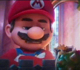 A Close Up Of A Mario Mascot Wearing A Red Hat And A Bow Tie GIF