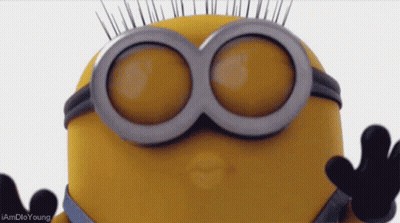 A Close Up Of A Minion Wearing Goggles And Giving A Kiss GIF