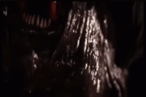 A Close Up Of A Monster 'S Mouth With A Red Tongue Coming Out Of It 'S Mouth . GIF