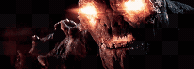 A Close Up Of A Monster With Glowing Eyes And Teeth GIF