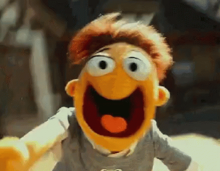 A Close Up Of A Muppet With His Mouth Open And His Eyes Closed . GIF