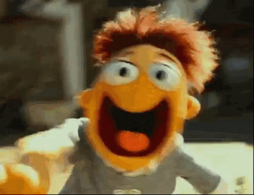 A Close Up Of A Muppet With His Mouth Open And His Tongue Out GIF