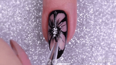 A Close Up Of A Nail With A Flower Design And The Words 20 Nails Made In Animatica GIF
