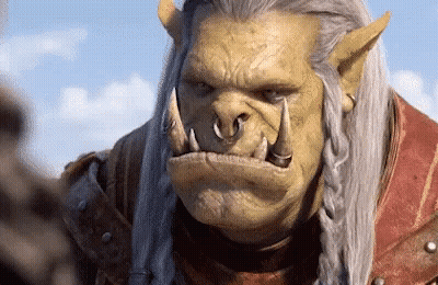 A Close Up Of A Orc With A Braided Hair Looking At The Camera GIF