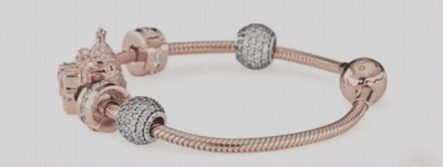 A Close Up Of A Pandora Bracelet With Various Charms On It GIF