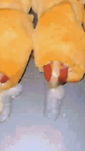 A Close Up Of A Pastry With A Strawberry Filling On A Blue Surface GIF