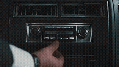 A Close Up Of A Person Adjusting A Radio In A Car . GIF