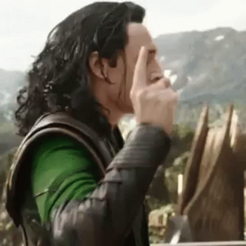 A Close Up Of A Person Covering Their Face With Their Finger . GIF