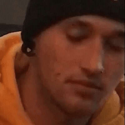 A Close Up Of A Person Covering Their Face With Their Hand While A Cat Looks On . GIF