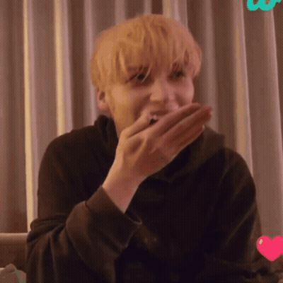 A Close Up Of A Person Covering Their Mouth With Their Hand GIF
