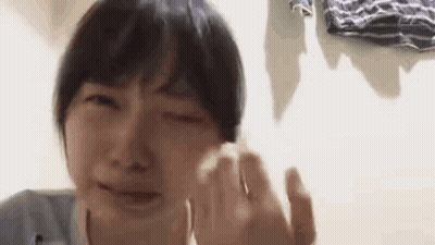 A Close Up Of A Person Crying With Their Eyes Closed . GIF