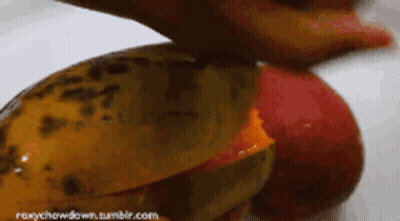 A Close Up Of A Person Cutting A Fruit With The Website Roxychowdown.tumblr.com In The Lower Right Corner GIF