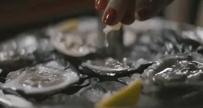 A Close Up Of A Person Cutting An Oyster With A Knife . GIF
