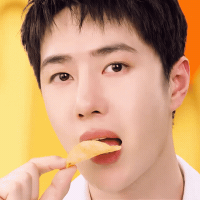 A Close Up Of A Person Eating A Slice Of Food GIF
