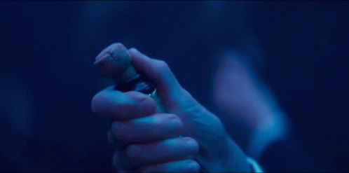 A Close Up Of A Person Holding A Bottle In Their Hand GIF