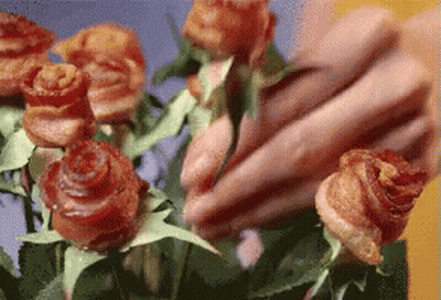 A Close Up Of A Person Holding A Bunch Of Flowers GIF