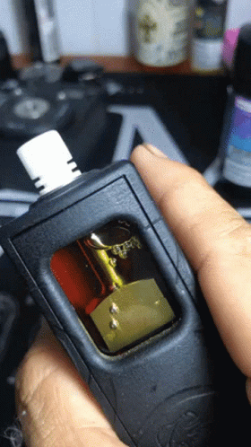A Close Up Of A Person Holding A Device With A Sticker On It That Says ' A ' On It GIF