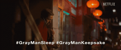 A Close Up Of A Person Holding A Gray Man Sleep Necklace GIF