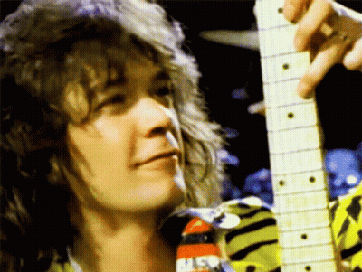 A Close Up Of A Person Holding A Guitar With A Nasa Logo On His Shirt GIF